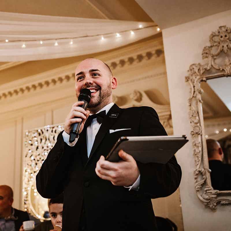 Chris on the microphone, hosting a wedding breakfast